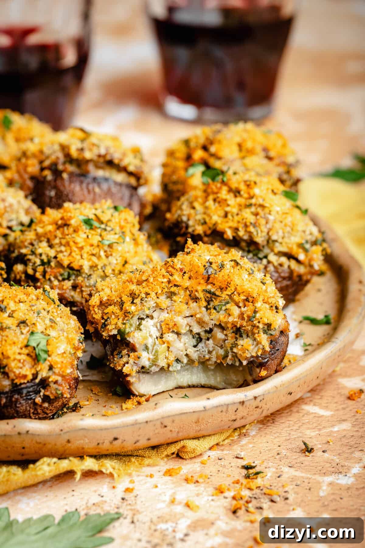Sausage Stuffed Mushrooms with Garlic and Parmesan 3 Sausage Stuffed Mushrooms on a plate. Bite taken out of one mushroom.
