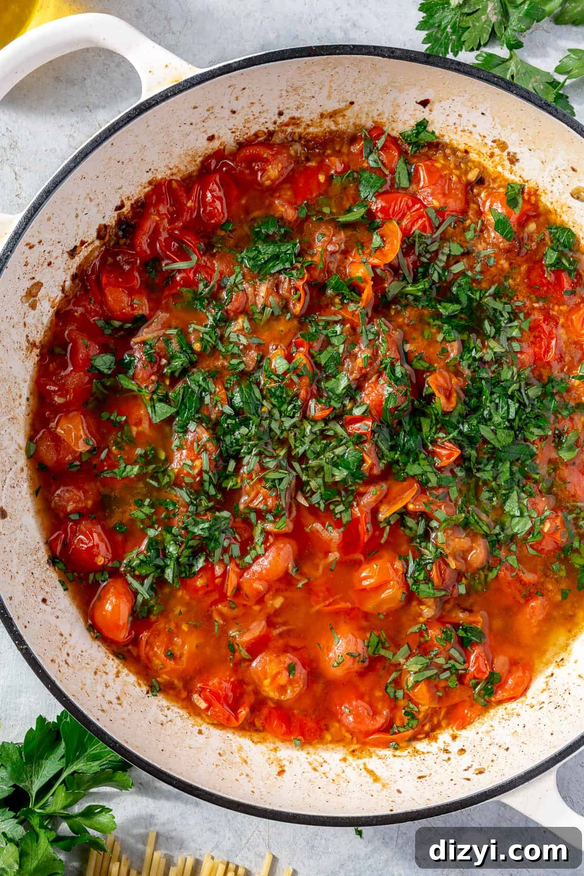 Tomato sauce for pasta in skillet. Herbs on top.