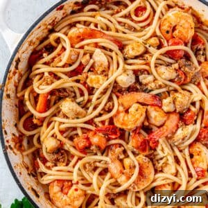 Pasta tossed with sauce and all of the seafood.