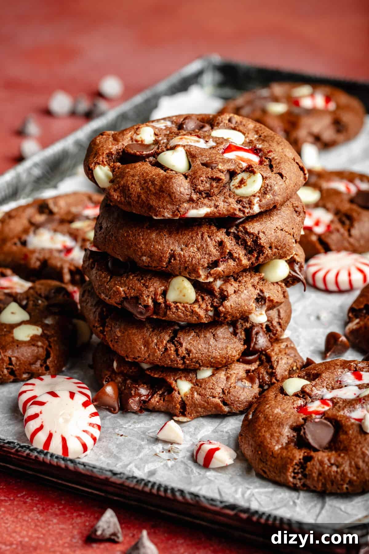 Double Chocolate Peppermint Cookies stacked on top of each other on a sheet pan.