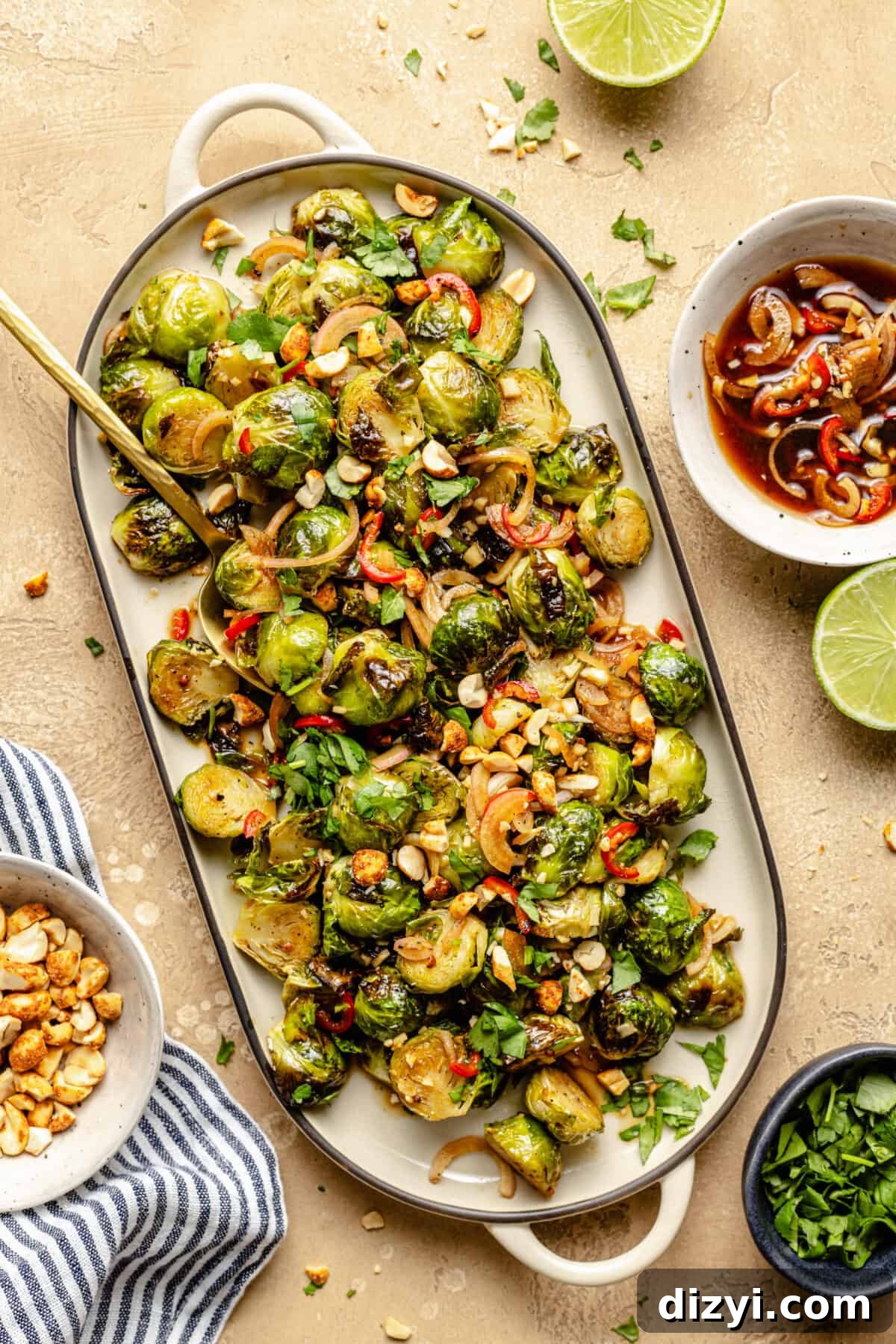 Nuoc Cham Brussels Sprouts on white serving tray. Garnishes scattered around.