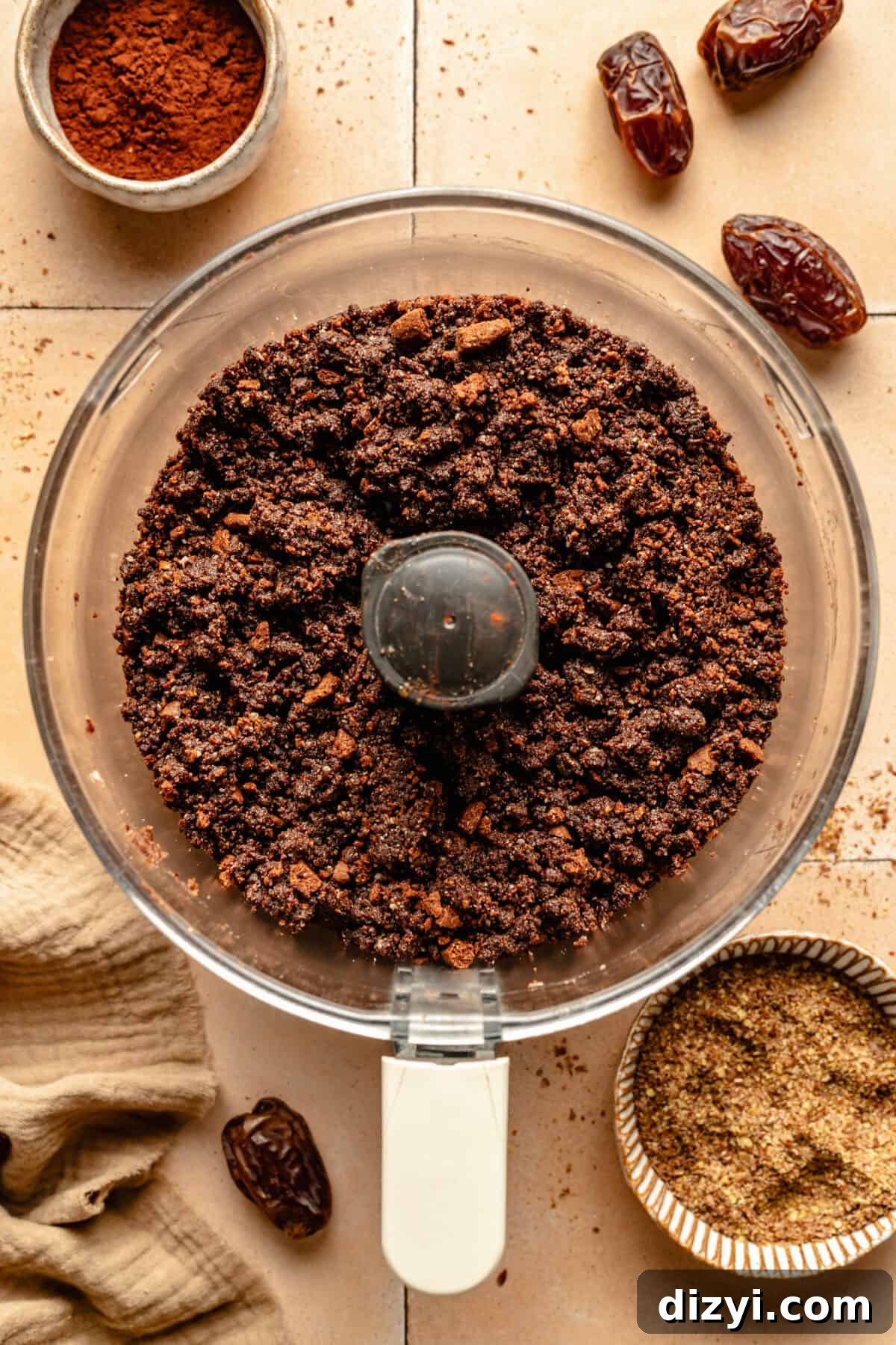 Energy bite base in food processor. Other ingredients scattered around.