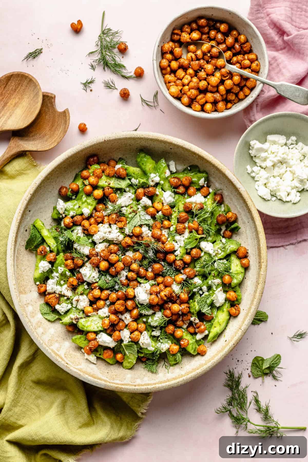 Salad in large bowl with feta and chickpeas scattered around.