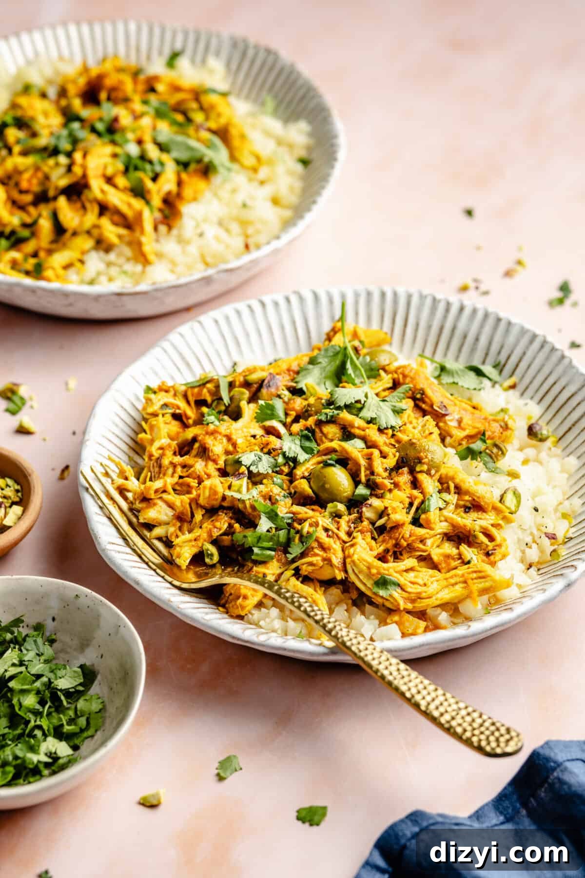 Slow Cooker Chicken Tagine plated in low white bowls.