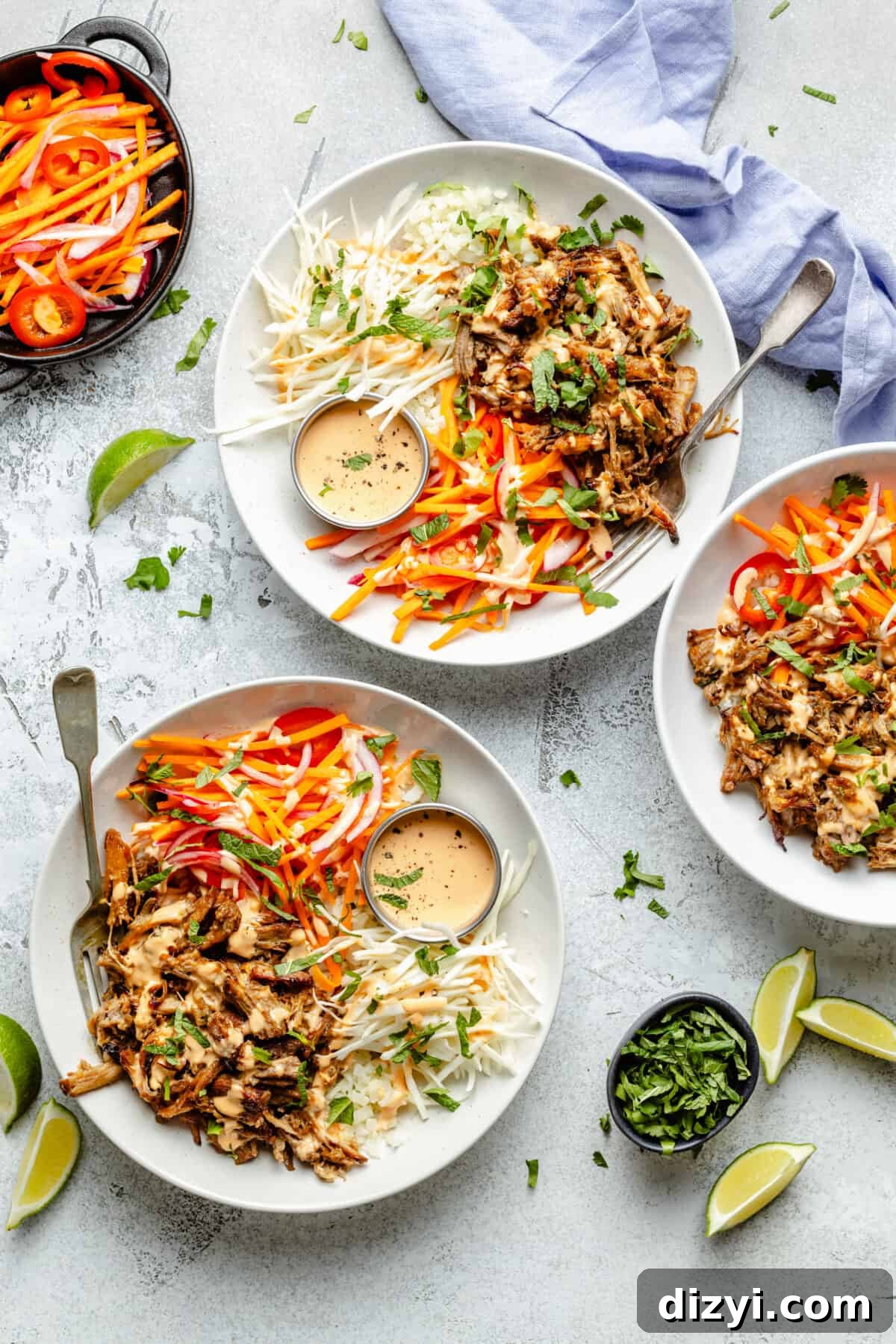 Slow Cooker Lemongrass Shredded Pork Bowls 2 Slow Cooker Shredded Lemongrass Pork in bowls with garnishes scattered around.