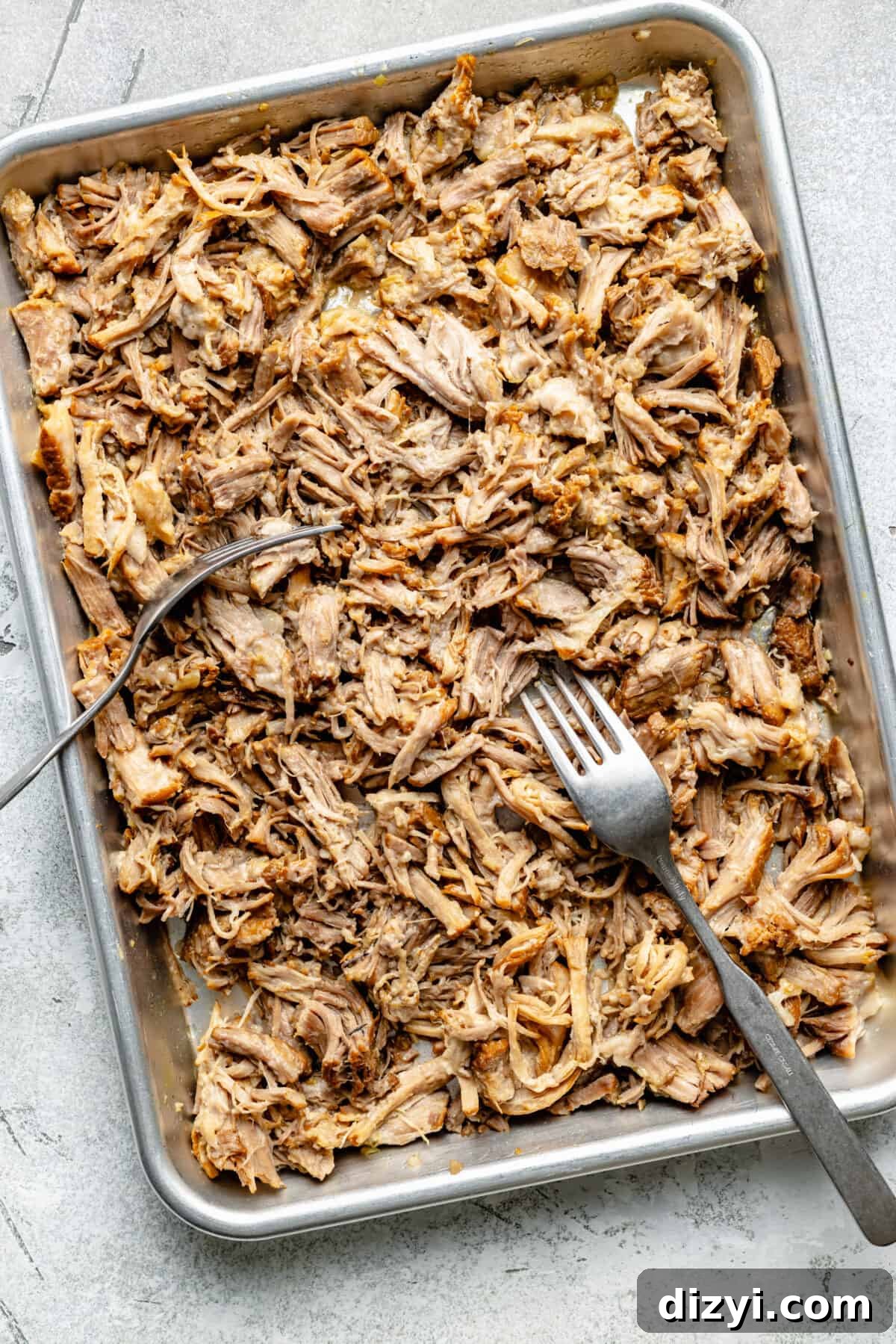 Slow Cooker Lemongrass Shredded Pork Bowls 5 Shredded pork on sheet pan. Two forks on pan.