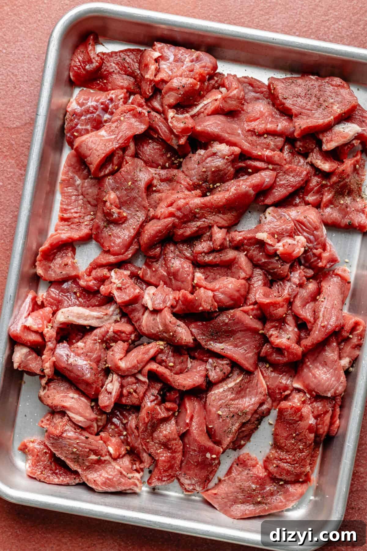 Sliced steak on sheet pan.