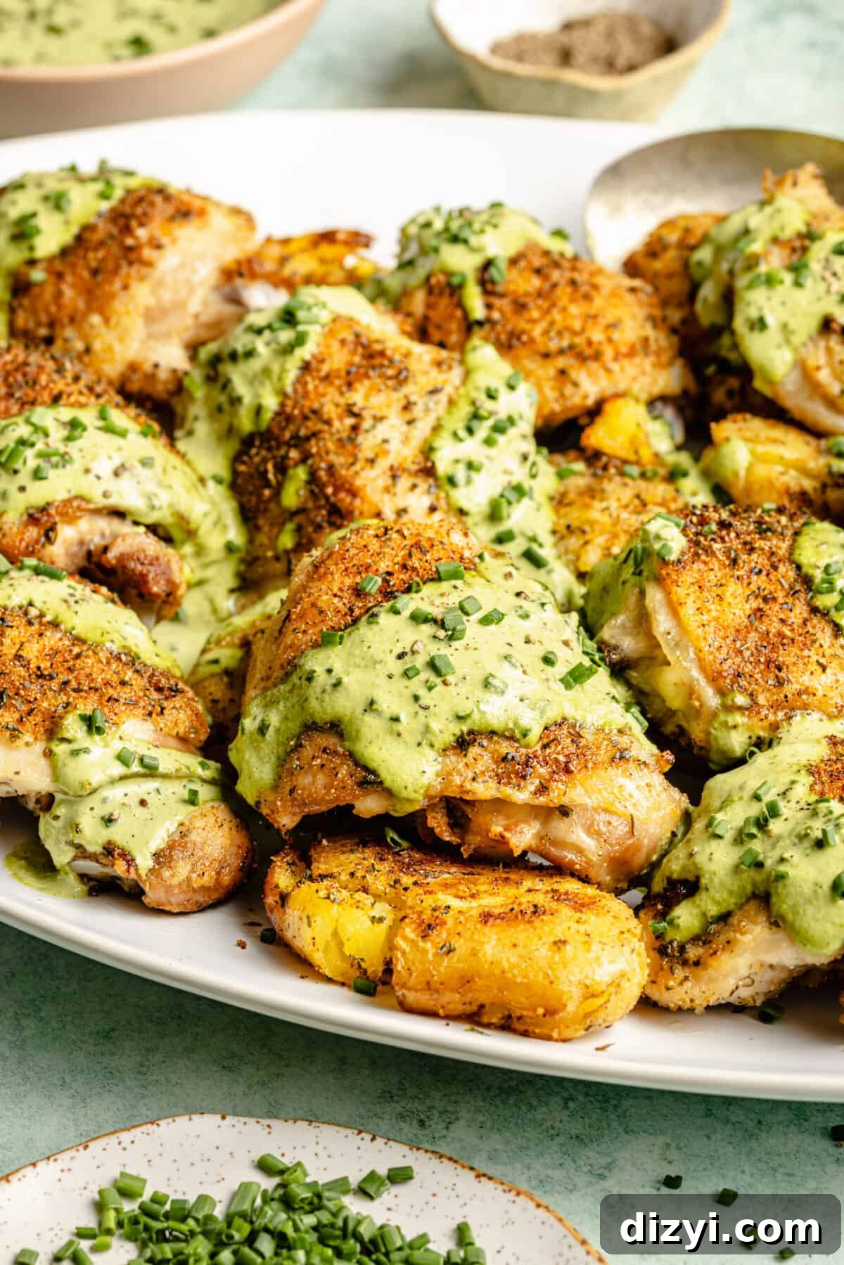 Herby Chicken Thighs with Smashed Chive and Onion Potatoes on platter.