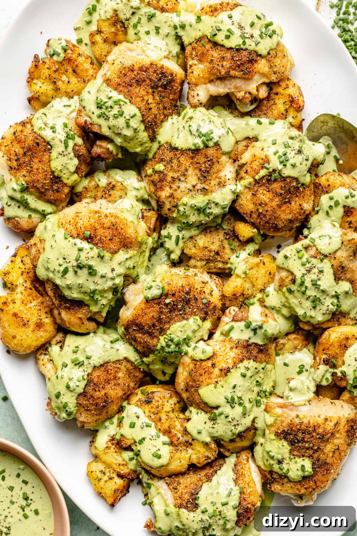 Herby Chicken Thighs with Smashed Chive and Onion Potatoes on platter.