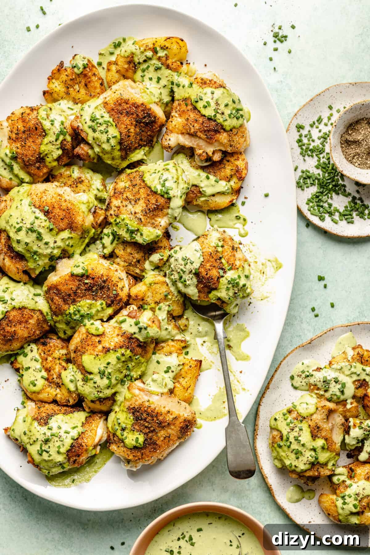 Herby Chicken Thighs with Smashed Chive and Onion Potatoes on platter.