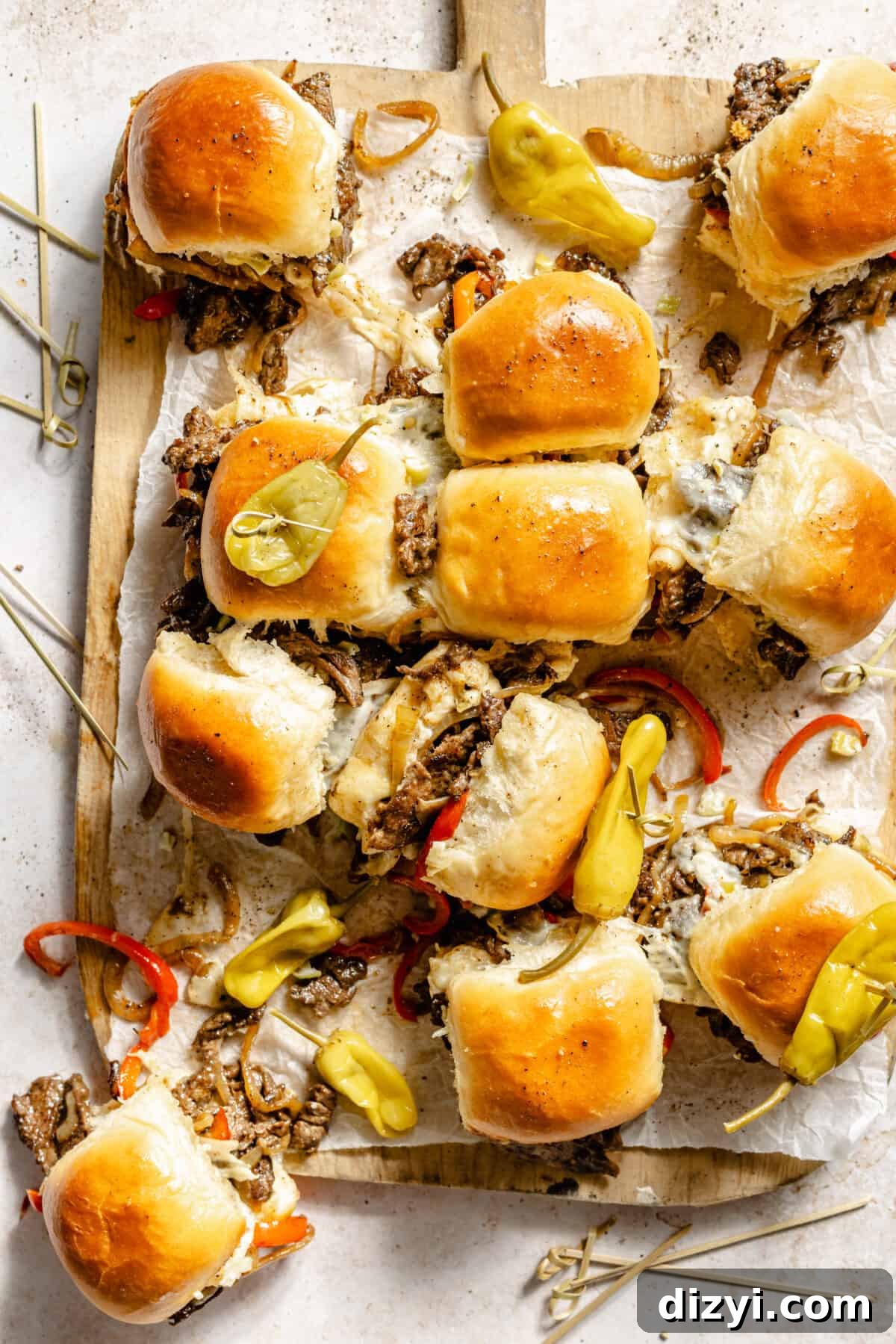 Philly Cheesesteak Sliders sliced and on cutting board.