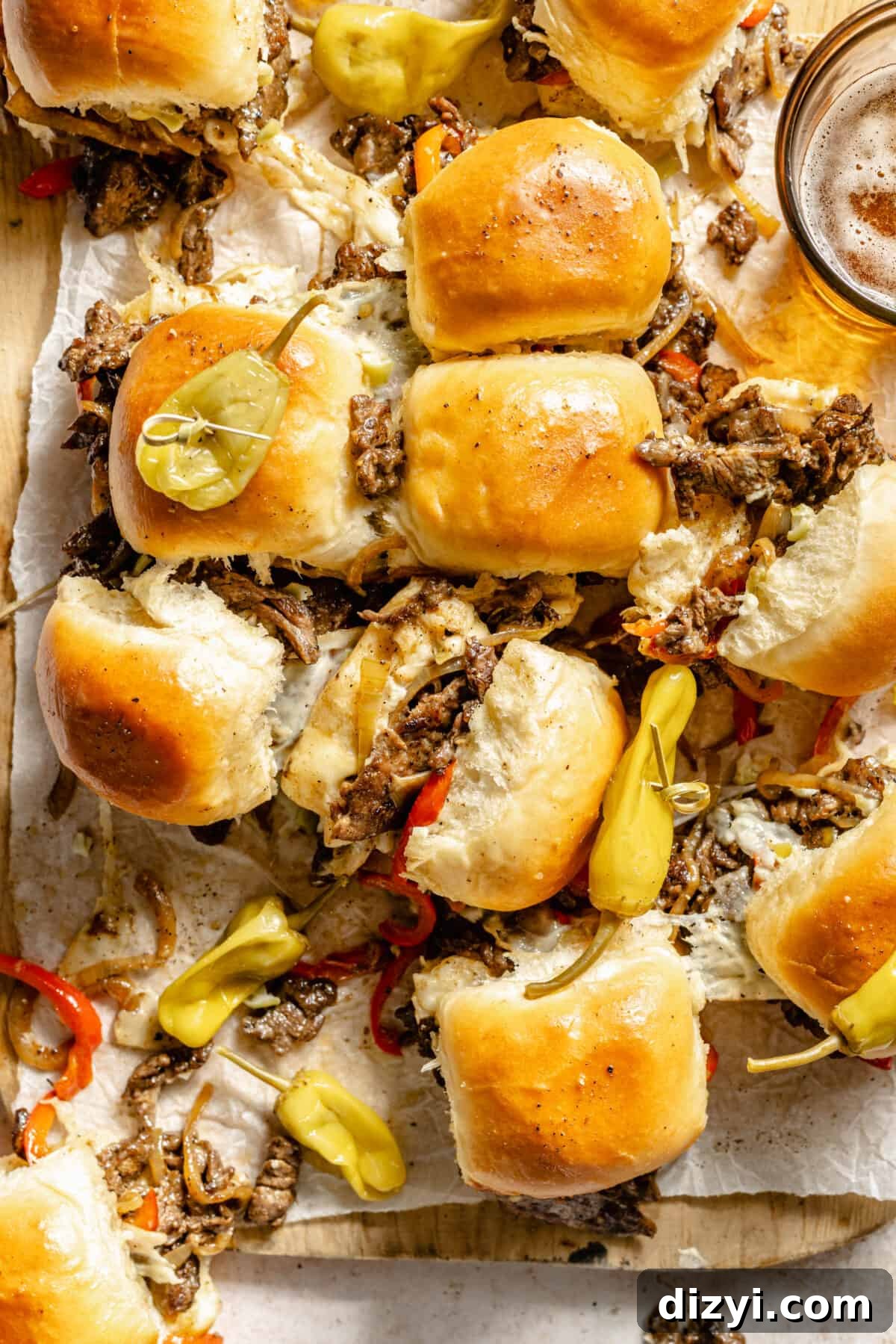 Philly Cheesesteak Sliders sliced and on cutting board.