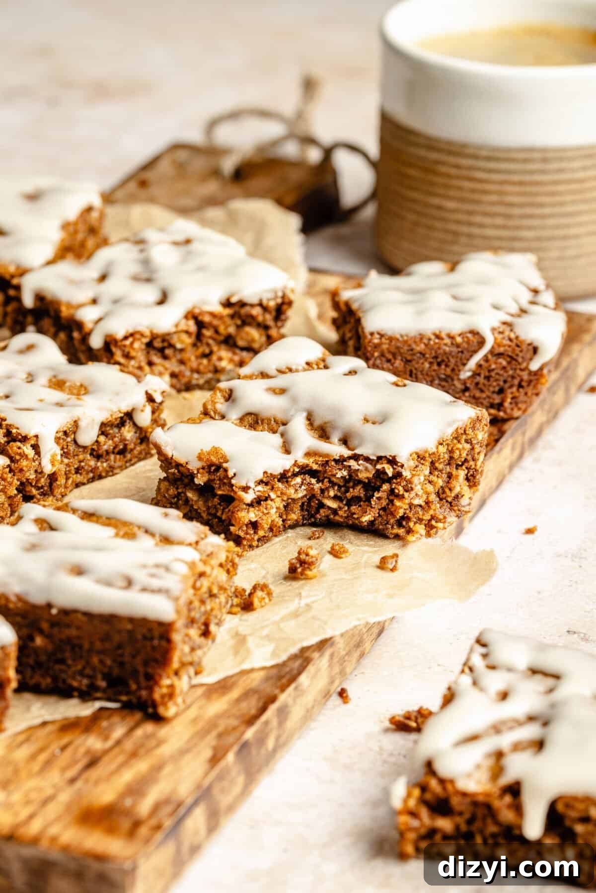 Iced Oatmeal Cookie Bars on board. Bite taken out of a bar.