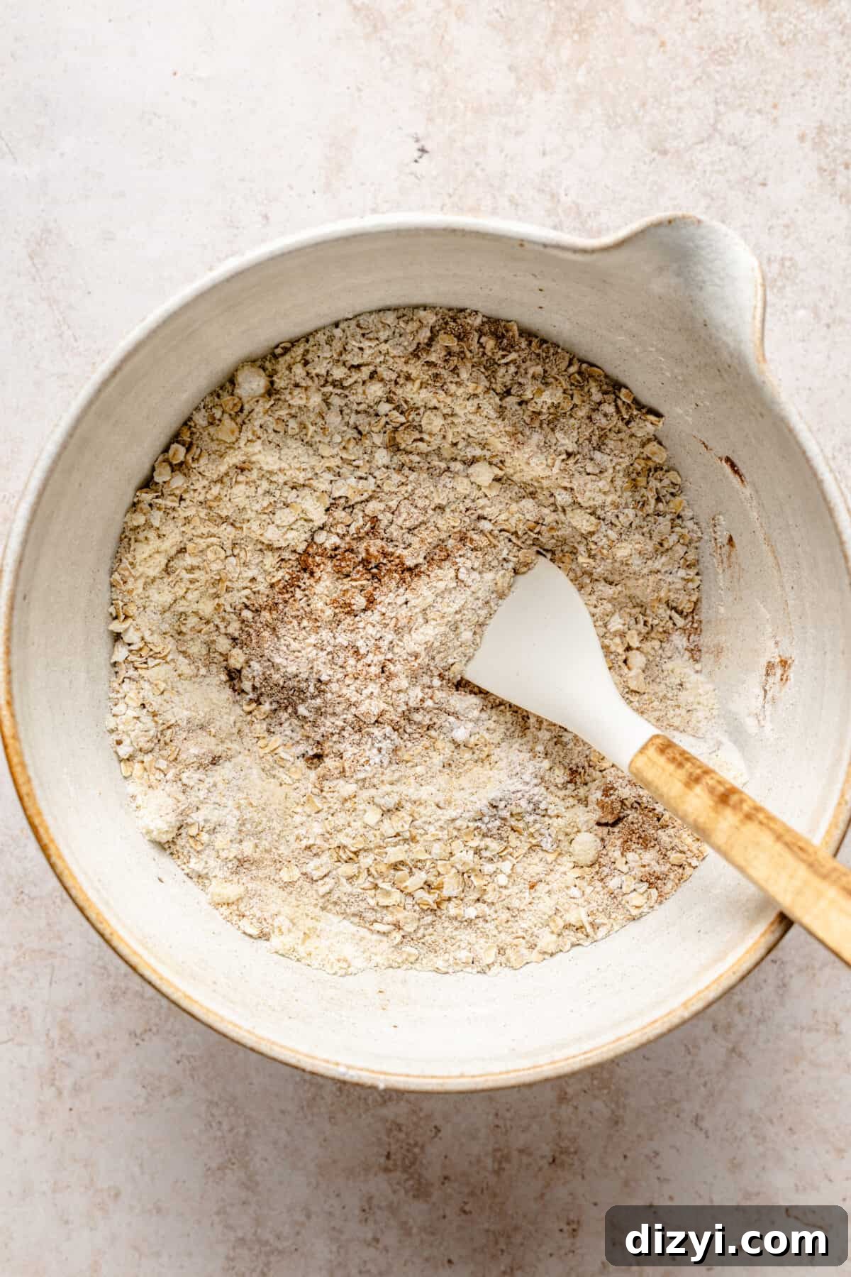 Dry ingredients mixed in white bowl.