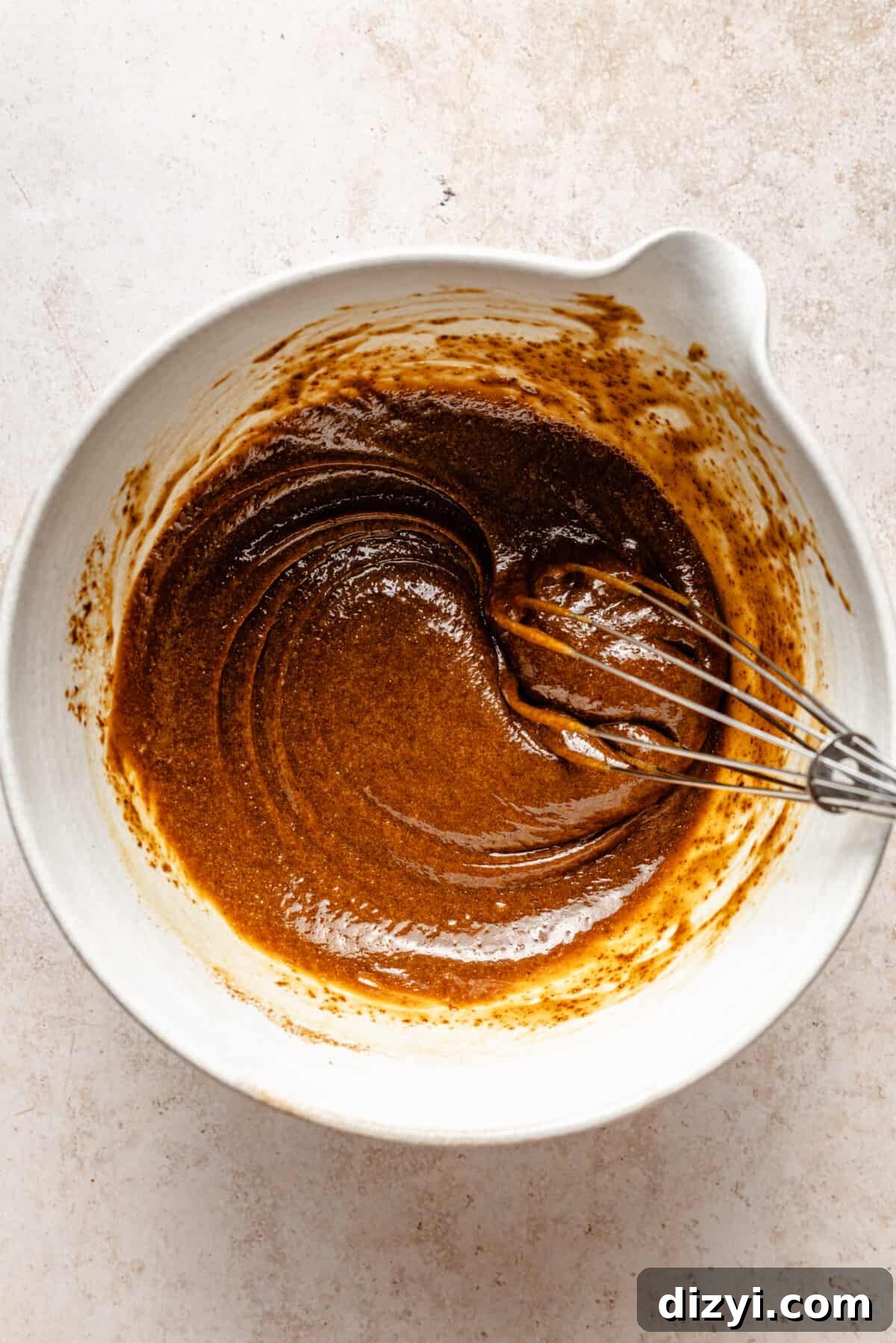 Wet ingredients mixed in white bowl.