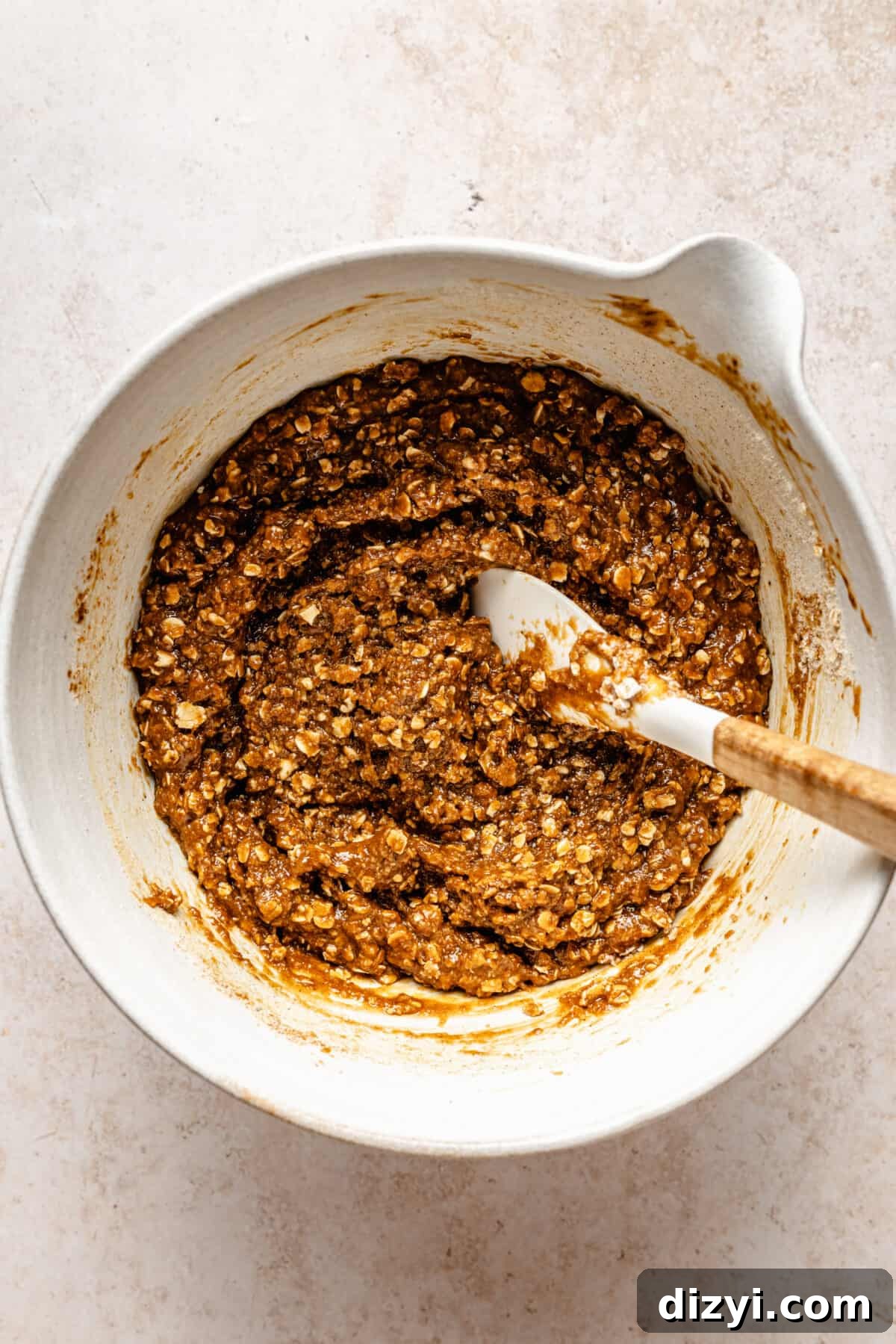 Wet and dry ingredients combined in white bowl.