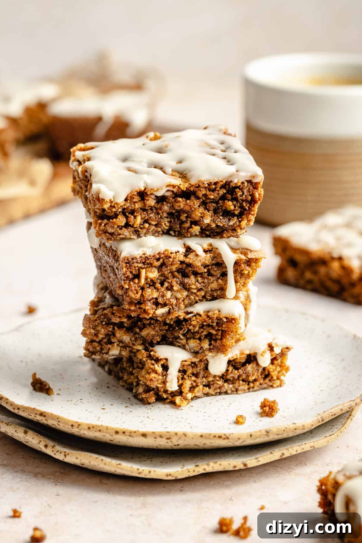 Three Iced Oatmeal Cookie Bars stacked on plate.