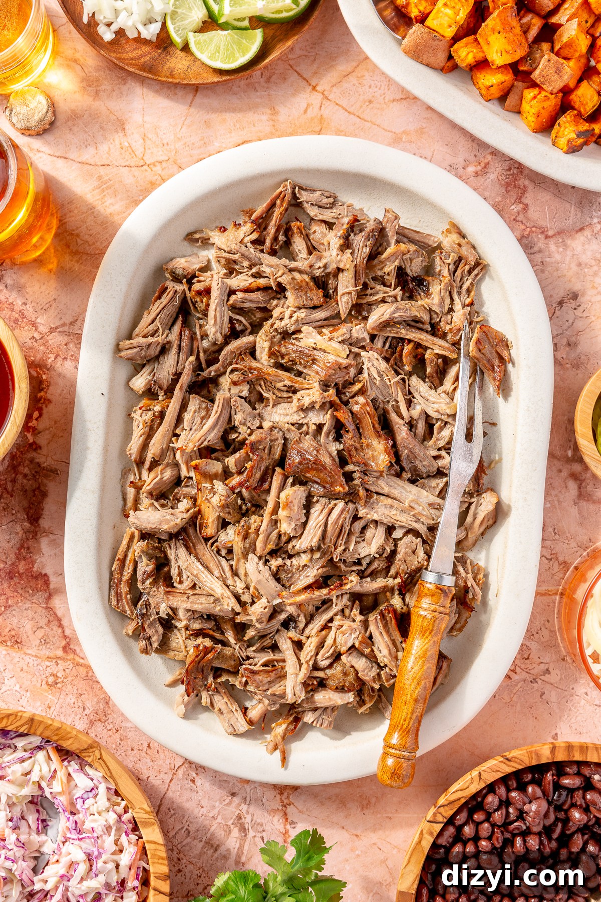 BBQ Pulled Pork on platter with other ingredients scattered around.