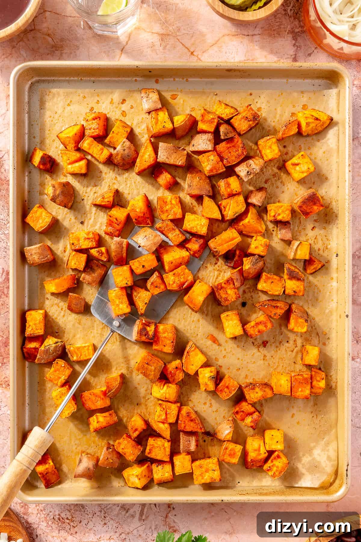 Diced, crispy sweet potatoes on sheet pan.
