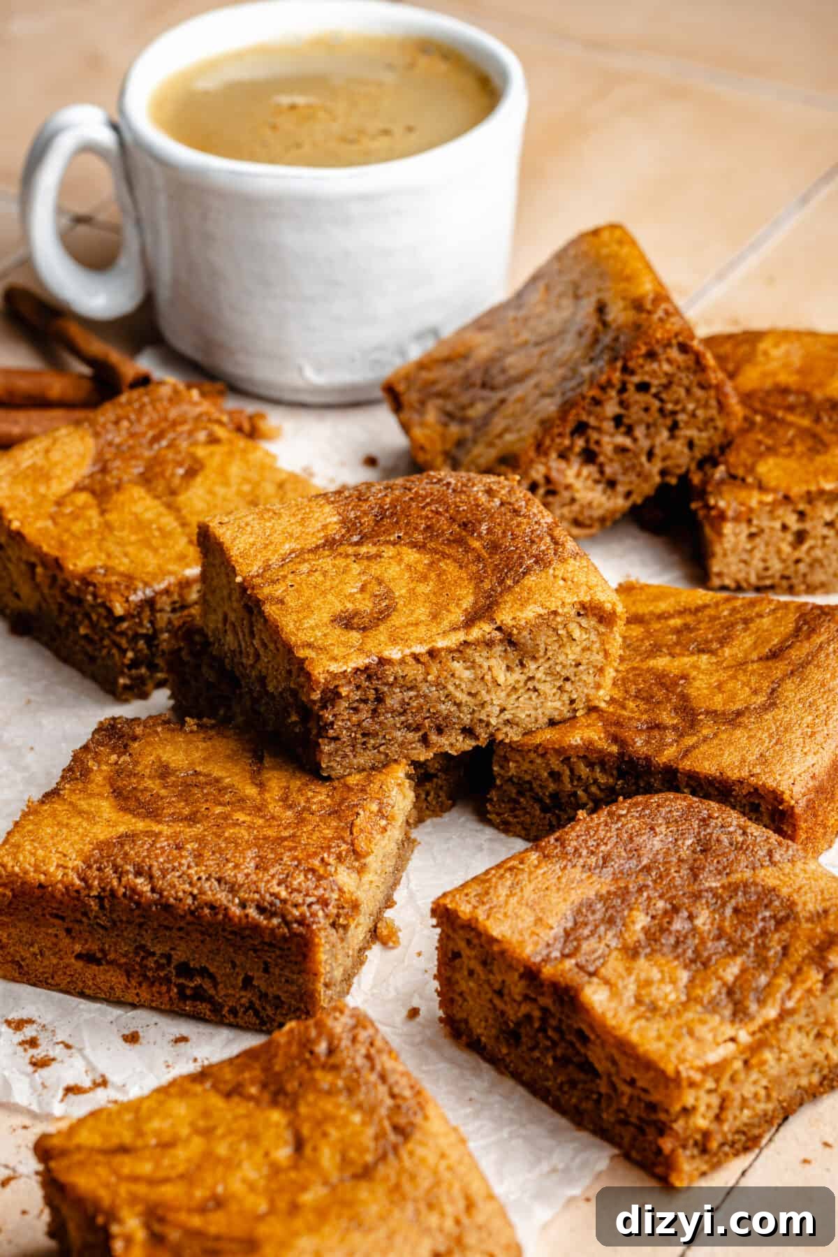 Paleo Cinnamon Swirl Cake cut and stacked. Cup of coffee in background.