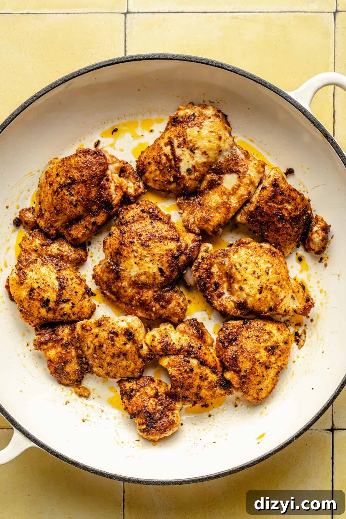 Browned chickened thighs in skillet.