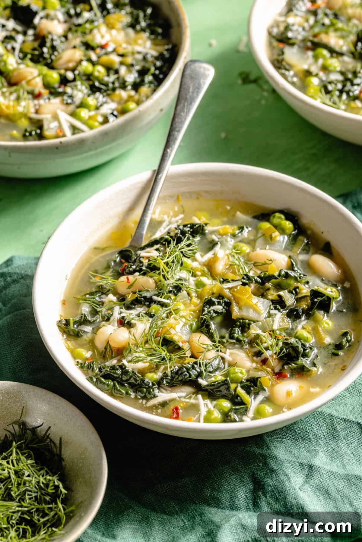 Spring Green Minestrone Soup Recipe with Fresh Spring Vegetables 3 Spring Green Minestrone in three bowls on green backdrop.