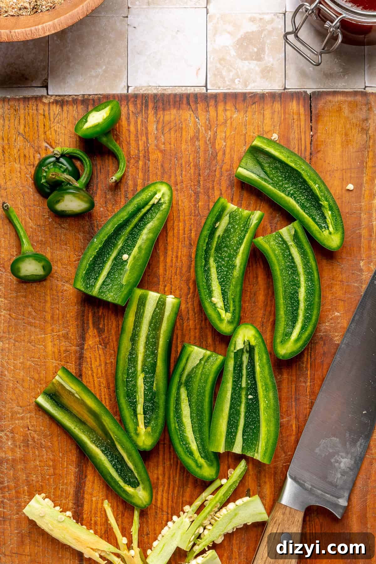 Sliced jalepenos on cutting board.