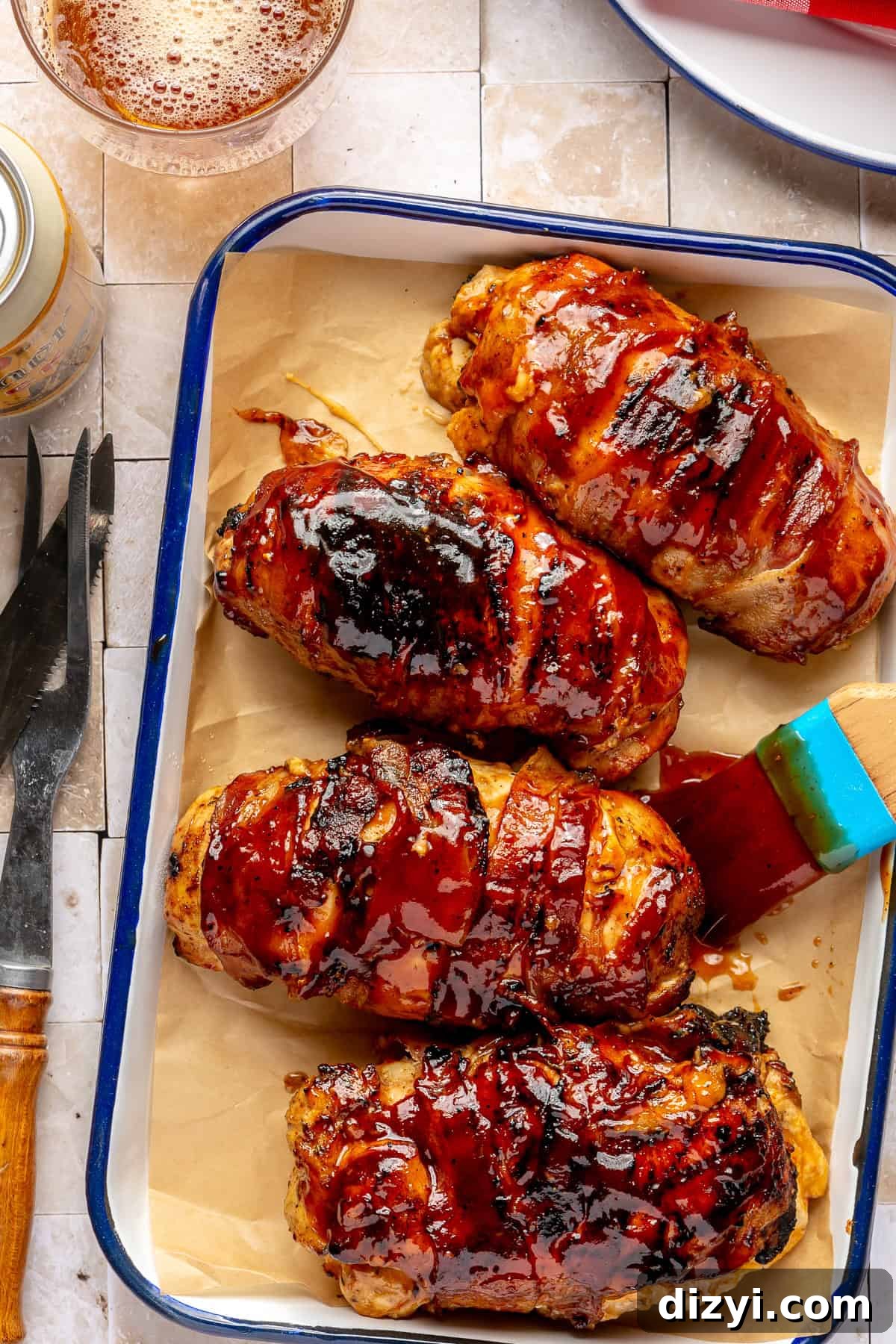 Bacon-wrapped chicken basted with BBQ sauce.