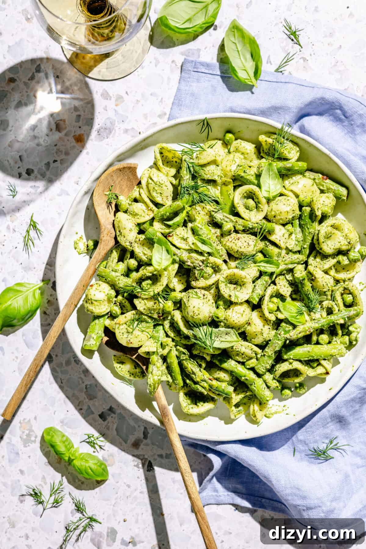 Creamy Green Goddess Pasta Salad with Avocado and Fresh Herbs 2 Green Goddess Pasta Salad in white serving bowl with two serving spoons.