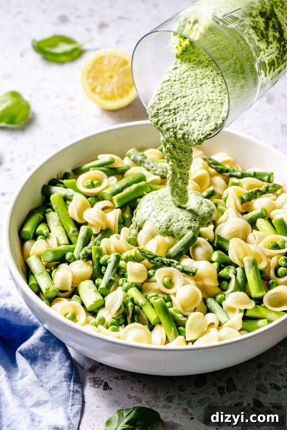 Creamy Green Goddess Pasta Salad with Avocado and Fresh Herbs 5 Green Goddess Pasta Salad in bowl with sauce pouring on top.