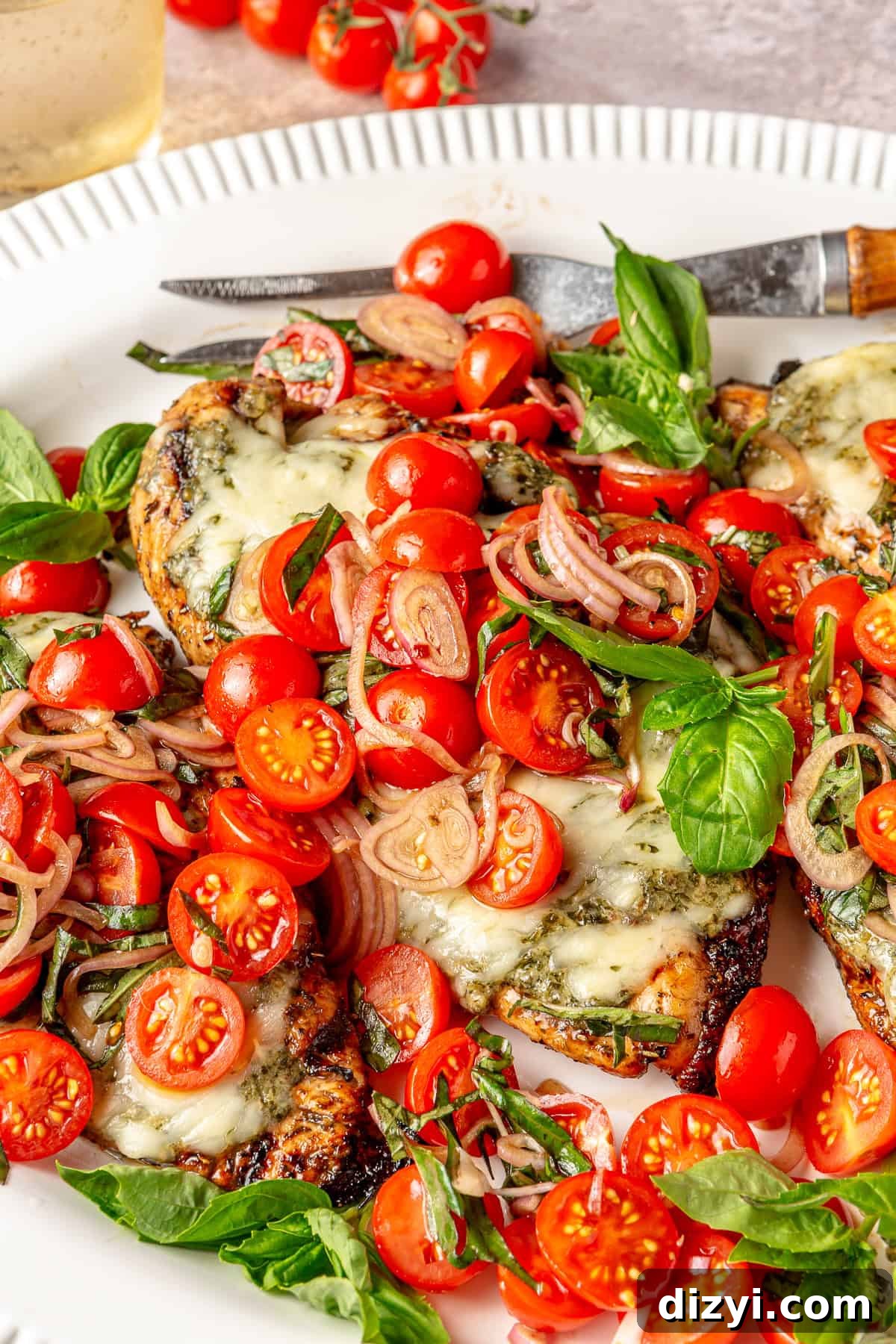 Close up of Caprese Grilled Chicken on white serving platter.