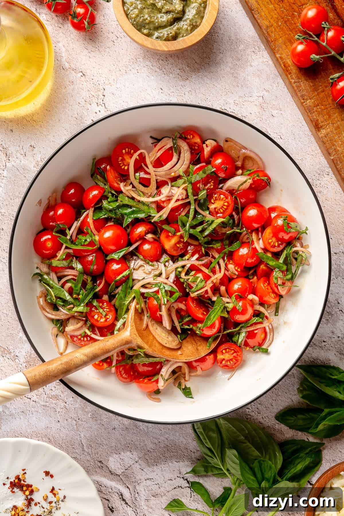 Cherry tomato topping in large bowl.