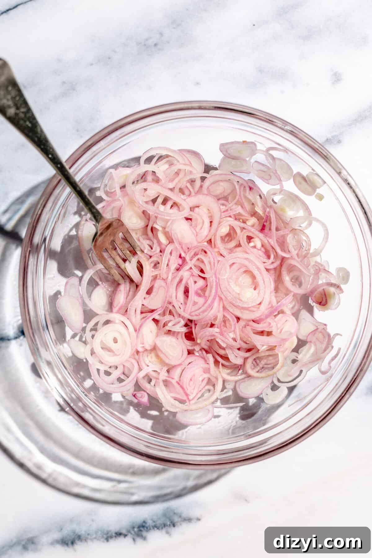 Quick-pickled shallots in glass bowl.