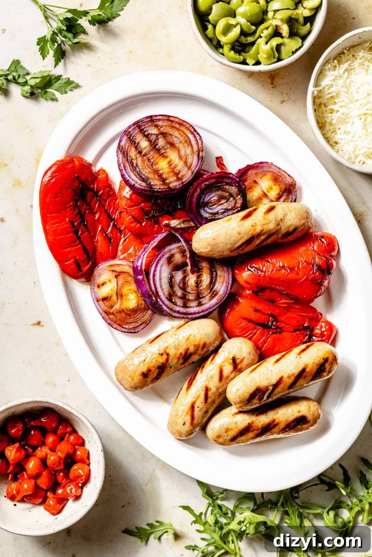 Grilled veggies and sausage on platter.