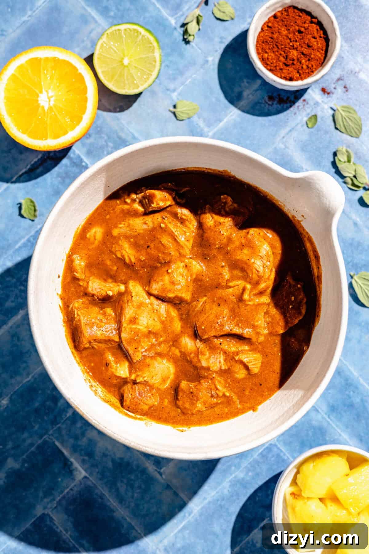 Pork Pastor marinating in white bowl.