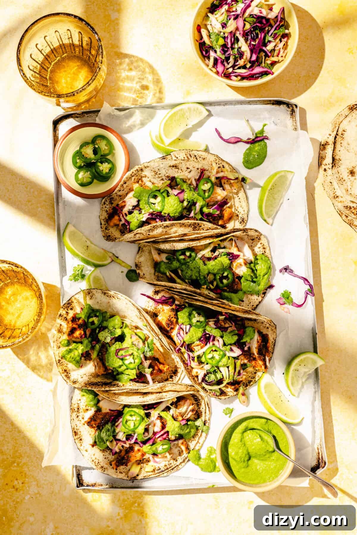 Grilled Fish Tacos with Citrus Slaw and Tangy Green Sauce 2 Grilled Fish Tacos with Citrus Slaw and Green Sauce assembled on tray.