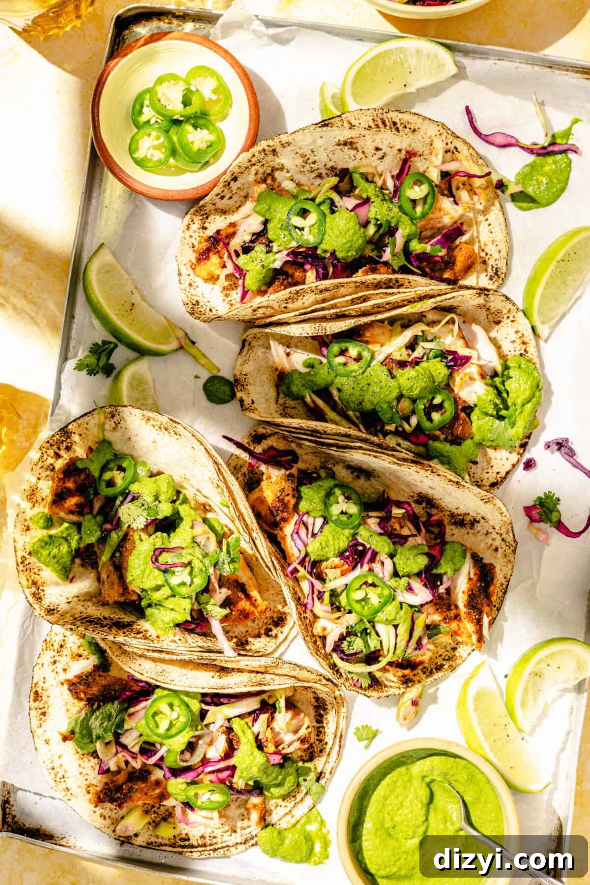 Grilled Fish Tacos with Citrus Slaw and Tangy Green Sauce 6 Grilled Fish Tacos with Citrus Slaw and Green Sauce assembled on tray.
