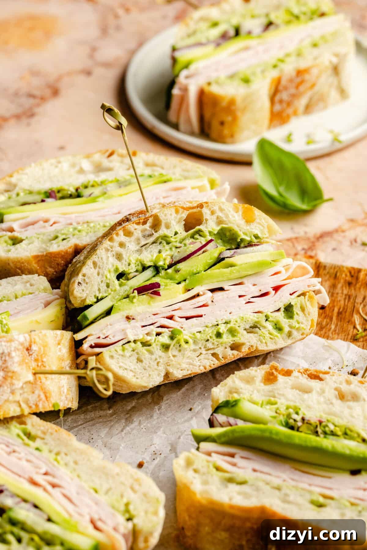 Close up of Green Goddess Party Sandwiches sliced on wood tray.