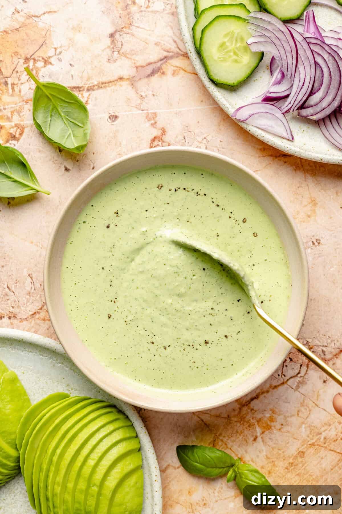 Cream bowl filled with Green Goddess dressing. Sandwich toppings in each corner.