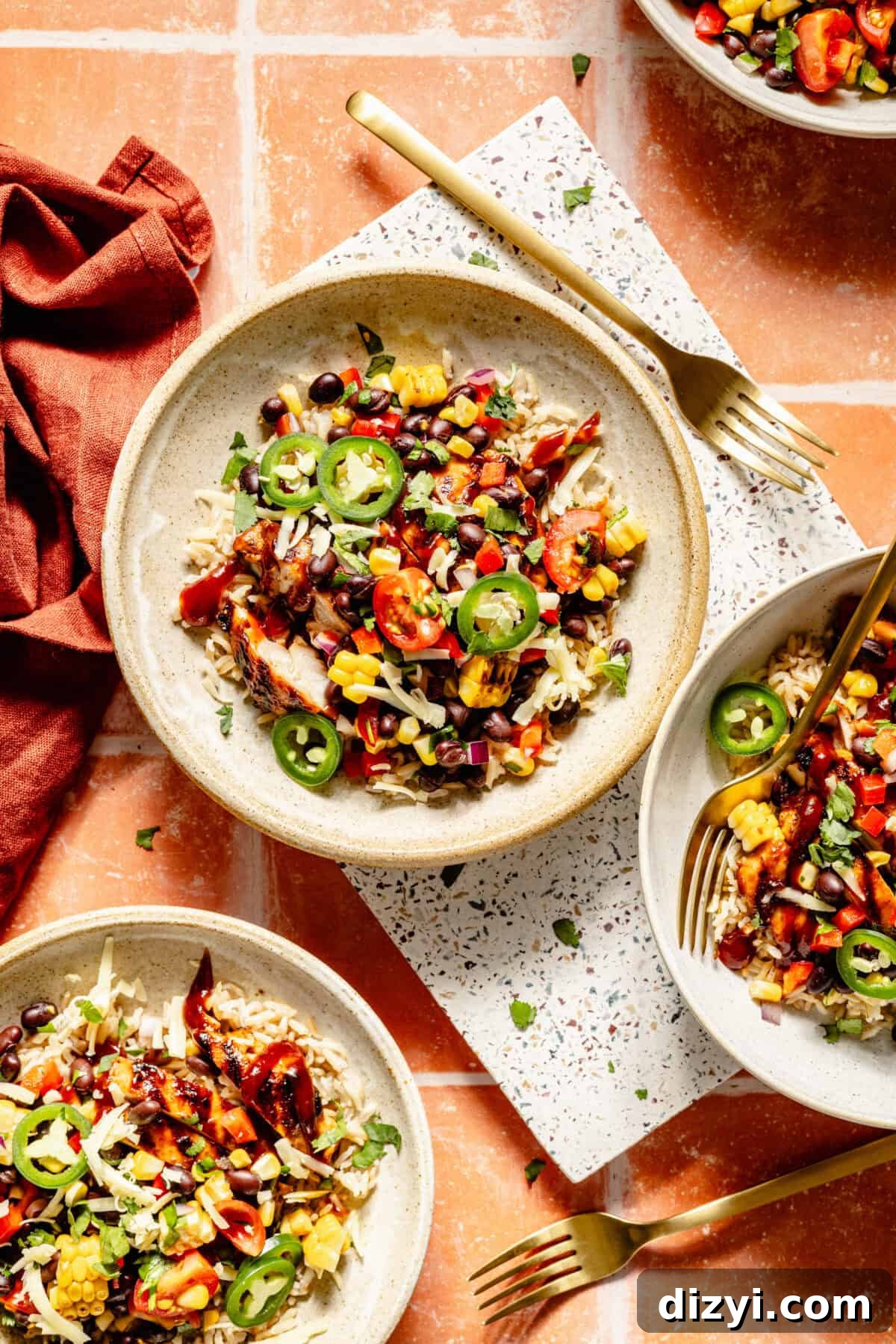 Grilled BBQ Chicken Bowls with Black Bean and Corn Salad Recipe 2 Three plated bowls of Grilled BBQ Chicken Bowls with Black Bean-Corn Salad.
