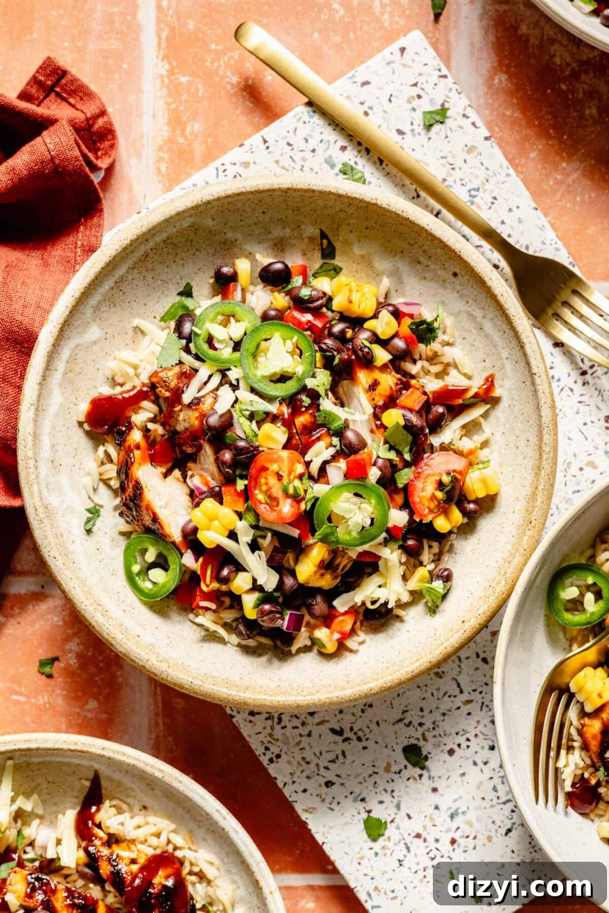 Grilled BBQ Chicken Bowls with Black Bean and Corn Salad Recipe 6 Grilled BBQ Chicken Bowls with Black-Bean Corn Salad in a bowl on tile.
