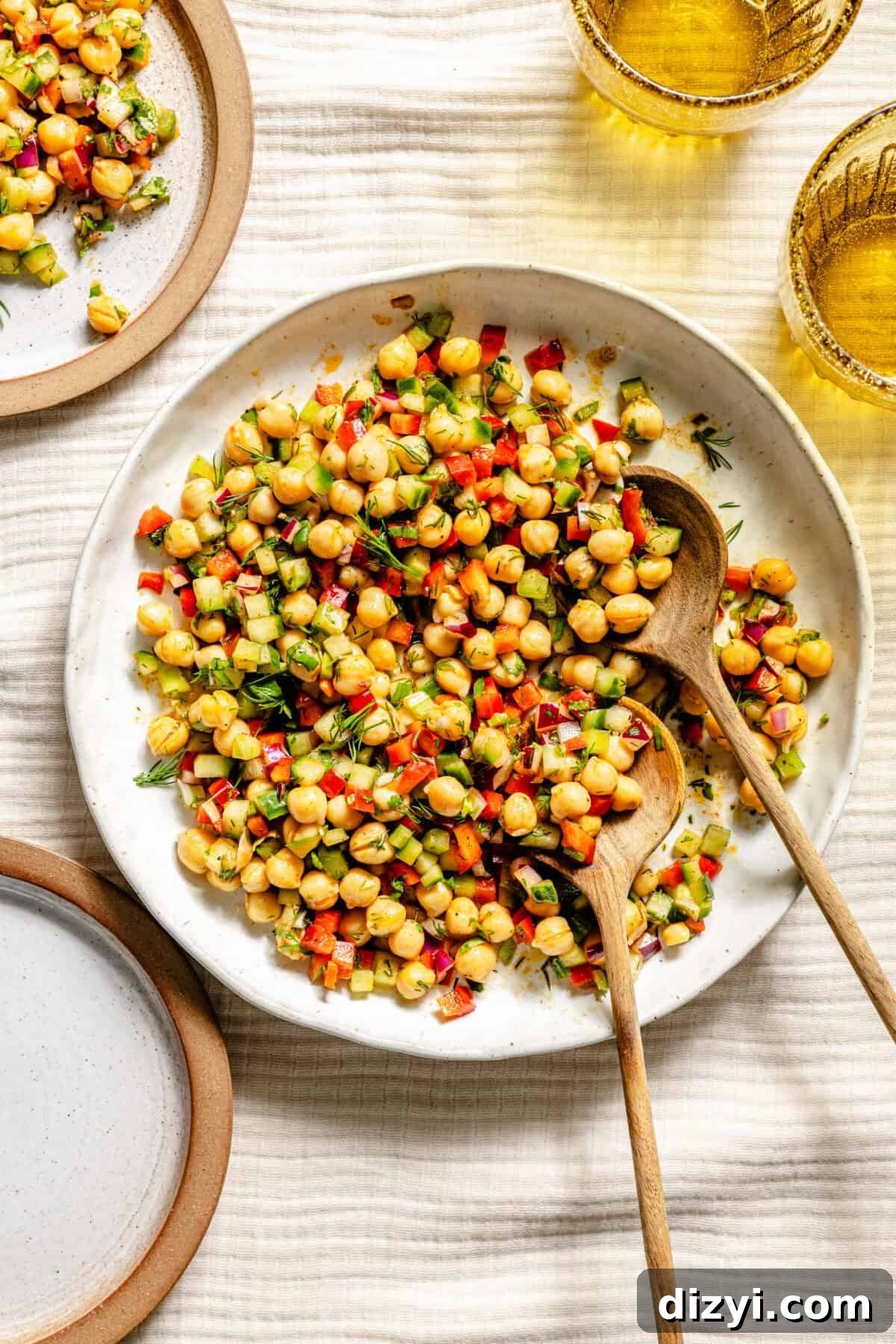 Serving bowl of Rainbow Chickpea Salad with a small plate next to it.