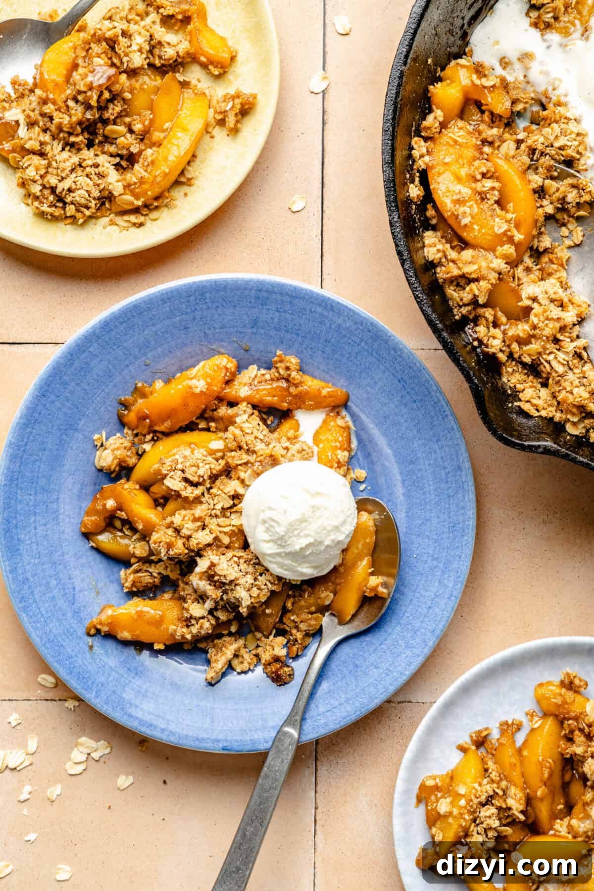 Simple Skillet Peach Crumble served on a blue plate with scoop of ice cream.