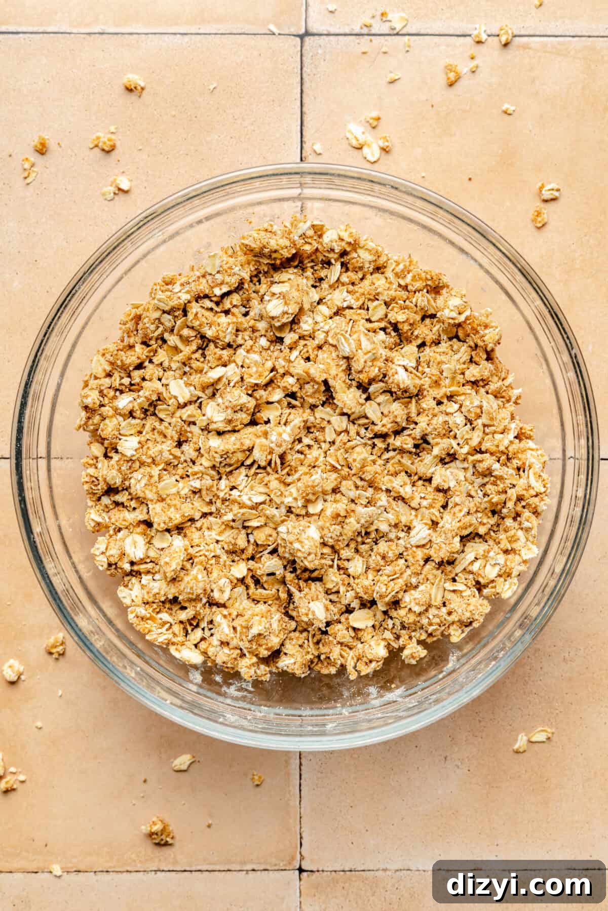 Crumble mixture in a clear mixing bowl.