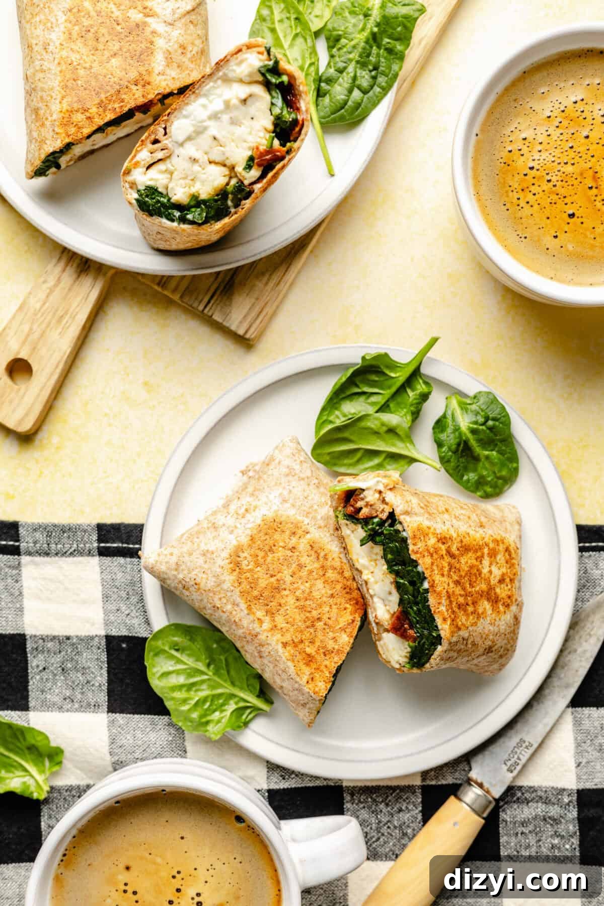 Copycat Starbucks Egg White Breakfast Wrap Recipe 2 Copycat Starbucks Egg White Breakfast Wraps sliced and on plates. Cups of coffee near.