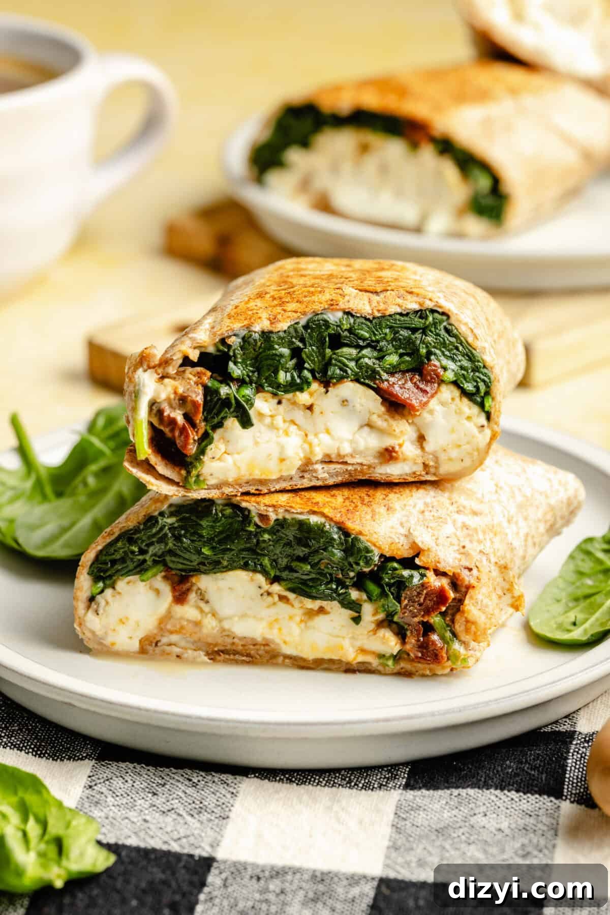 Copycat Starbucks Egg White Breakfast Wrap Recipe 3 Copycat Starbucks Egg White Breakfast Wrap cut and stacked on plate.