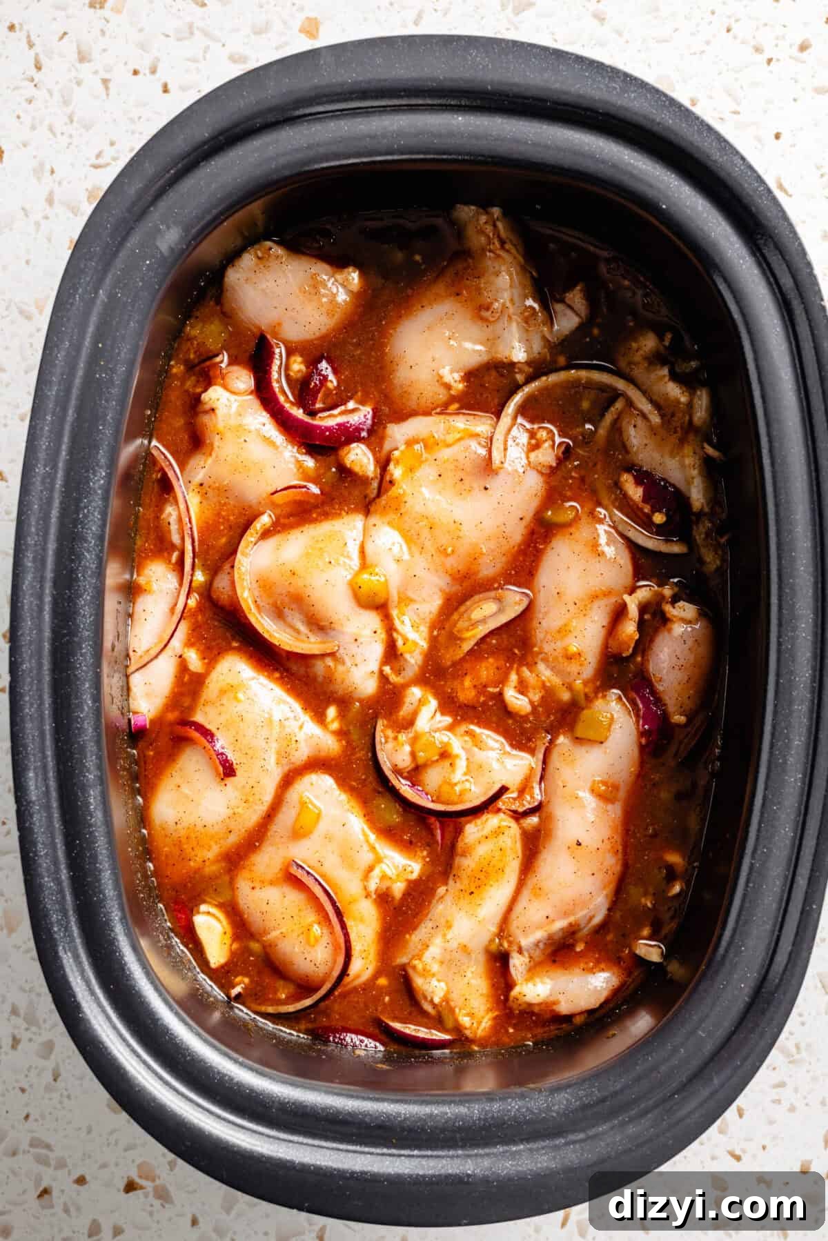 Slow Cooker BBQ Chicken Tacos with Shredded Chicken 3 The chicken, sauce, and onions in the bottom of the slow cooker.