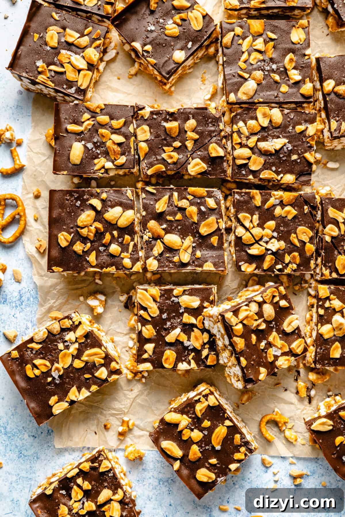 The finished Gluten-Free Take 5 Bars cut into squares on a countertop with parchment paper.