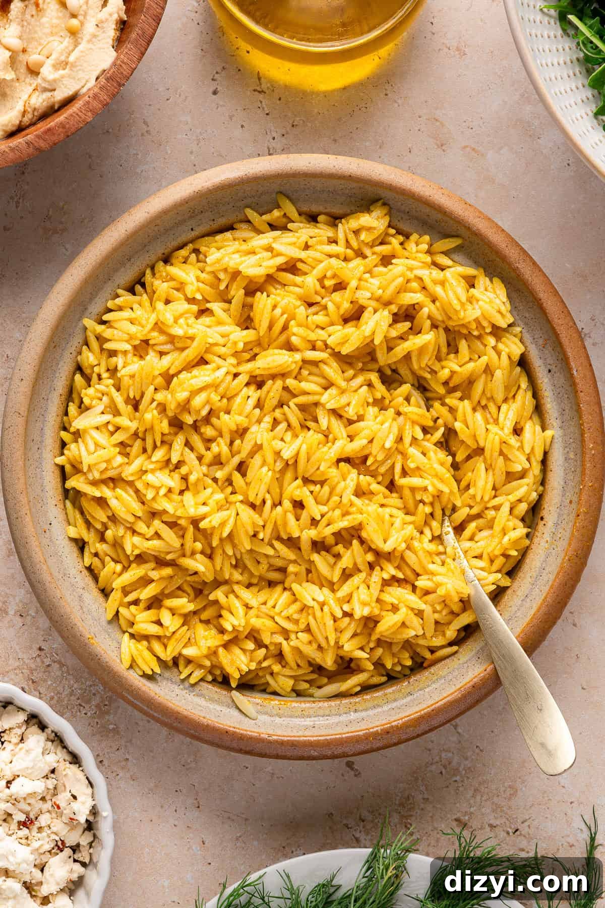 Seasoned orzo in a brown bowl.