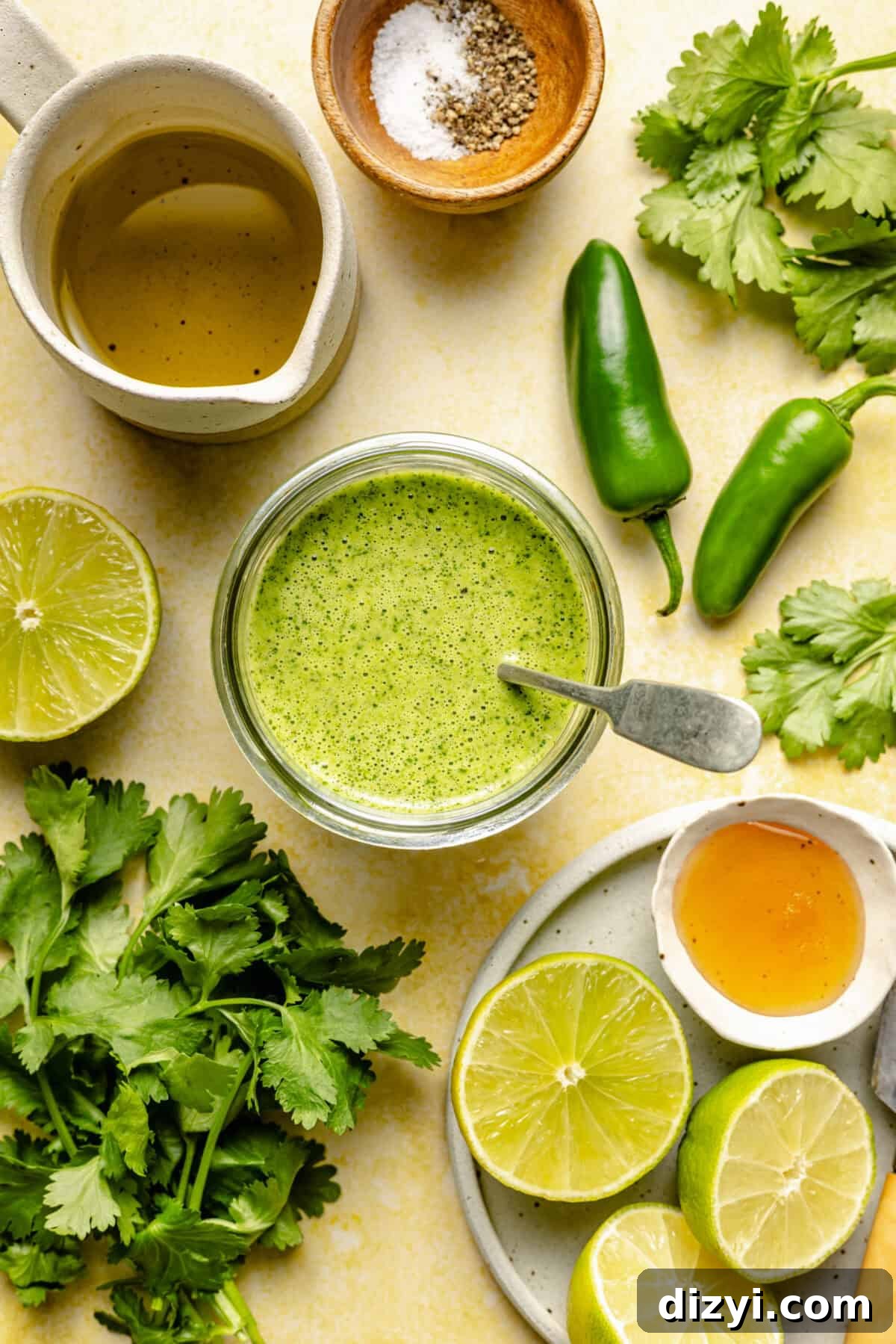 Meal-Prep Taco Bowls with Jalapeno Dressing 5 The ingredients needed to make the avocado-lime dressing for these taco bowls, plus a jar of the finished salsa with a spoon in the middle.